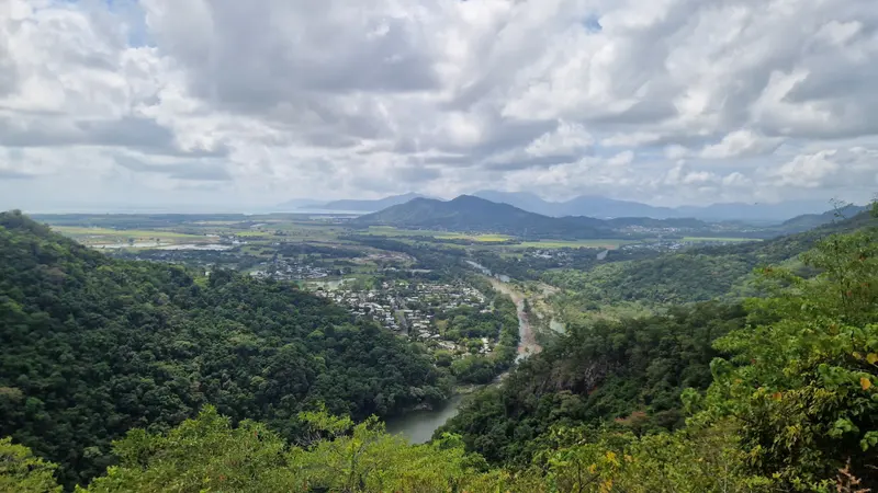 The Barron River winding through a green valley towards the coast, seen from the range