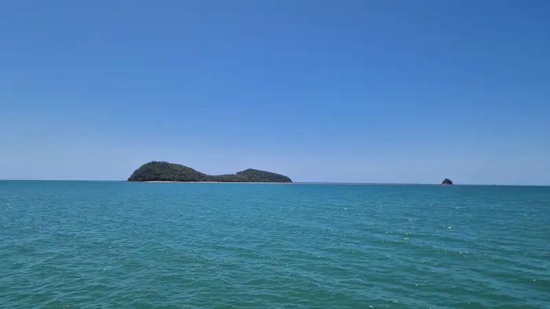 Double Island, a green twin-humped island, across turquoise water from Palm Cove