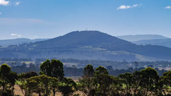 The photo depicts Mount Taylor, a prominent mountain located just north of Bairnsdale in East Gippsland, Victoria, Australia. The mountain is a well-known landm