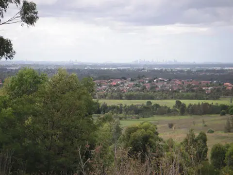 View of the city of Sydney taken from the lookout in Western Sydney Regional Park. The Sydney Harbour Bridge can be viewed in the middle of the horizon with the