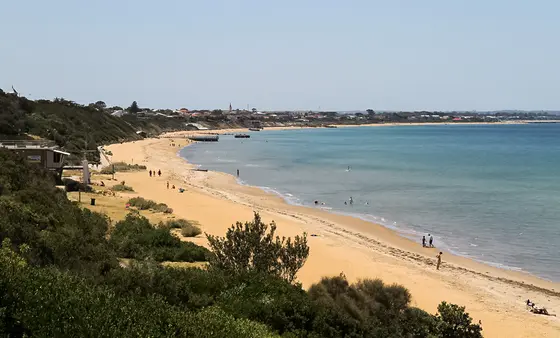 Looking south-east over Mentone Beach and Beaumaris Bay with the Mentone Lifesaving Club to the far left of image, Mentone, Victoria, Australia.