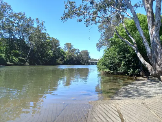 Photo of Nerang River boatramp at Arthur Earle Park in Nerang, Queensland, Australia. Bridge in distance is the Pacific Motorway.