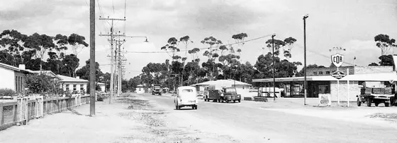 A panoramic view of Bagster's Road, the main thoroughfare in the suburb of Salisbury North, South Australia. It shows houses, electricity (Stobie) poles, cars a
